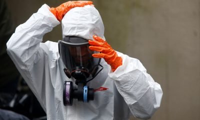 A Servpro worker takes off protective gear after working on deep cleaning the Life Care Center of Kirkland, a long-term care facility linked to several confirmed coronavirus cases, in Kirkland, Washington, U.S. March 13, 2020.  REUTERS/Lindsey Wasson