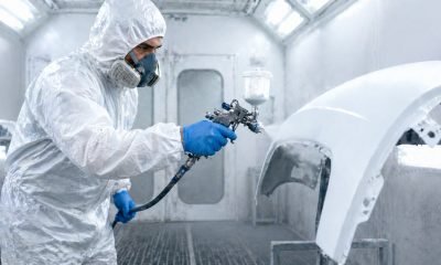 worker wearing disposable protective coverall for spray painting