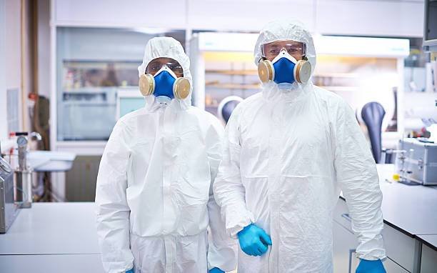 two-lab-workers-in-protective-coveralls